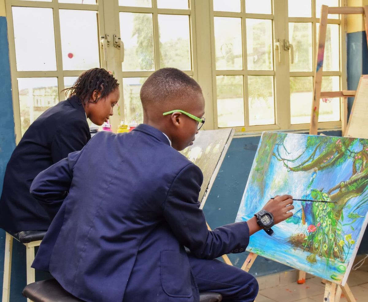 Pupils painting at easels